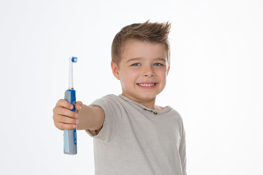 kid exhibits his brand new electric toothbrush