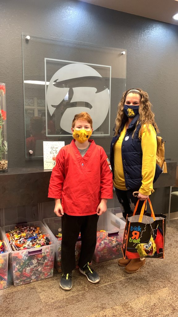 Young boy bringing in candy for the candy buy-back event.