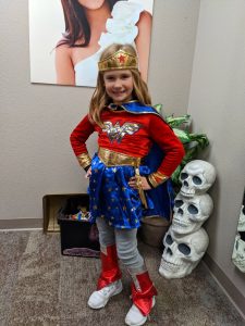 Young girl in a Wonder Woman Halloween costume